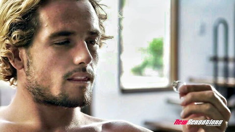 Tyler Nixon shirtless, intense gaze in domination scene with Asian Katana