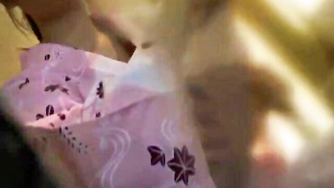 Blurry close-up of pink floral lace lingerie fabric teasingly stretched