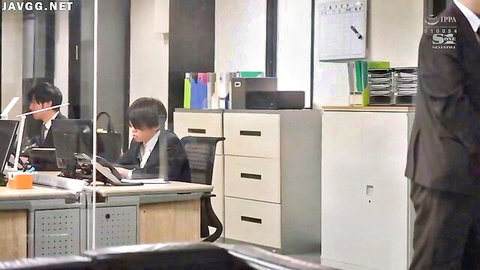 Japanese businessmen in suits working at desks in modern office