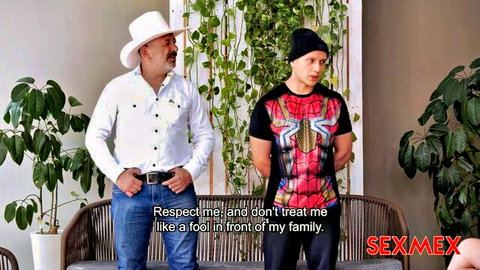 Cowboy dom in white hat confronts submissive guy in Spider-Man shirt demanding respect amid plants