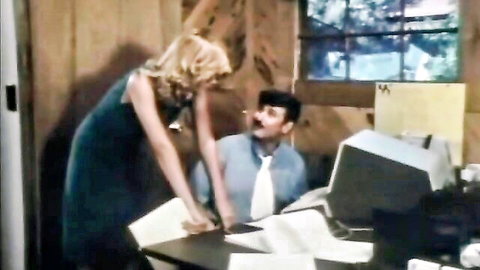 Vintage office tease with blonde babe in green dress leaning over suited man