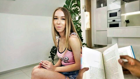 Nataly Gold reading book seductively in pink tank top and shorts