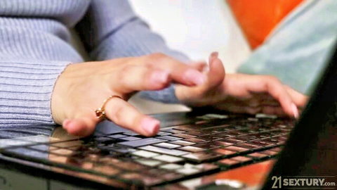 Leya Desantis typing on laptop in cozy sweater, teasing preview