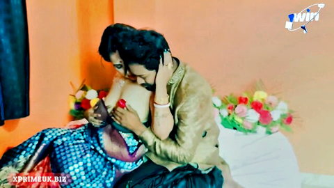 Passionate Desi honeymoon couple in steamy embrace with exposed breast
