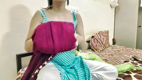 Desi Indian aunty in blue salwar kameez holding purple dupatta, teasing pose