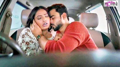 Passionate Indian couple kissing intensely in car backseat with babe moaning in pleasure