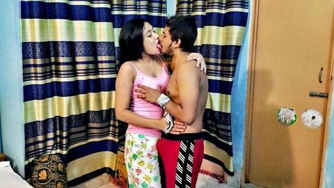 Passionate Indian couple kissing intimately, babe in pink top embraces shirtless boyfriend