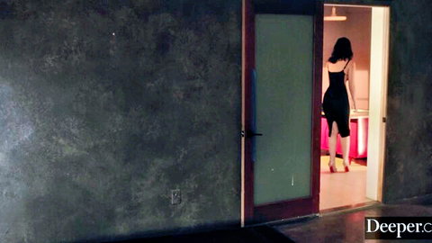 Curvy brunette babe in tight black dress looks back teasing big ass in doorway