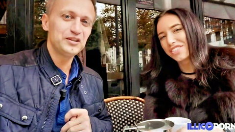 Ukrainian beauty in fur coat smiles with stud at outdoor cafe tease