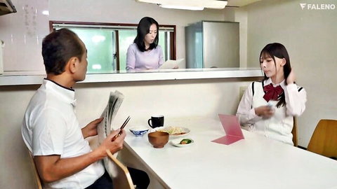 Japanese schoolgirl in white blouse and red bow tie at table with adults