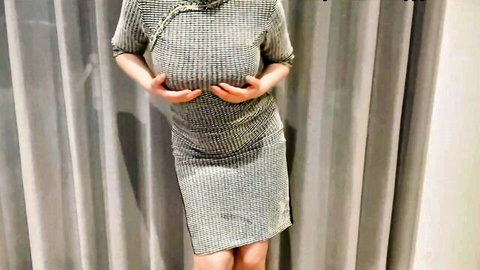 Busty Asian babe squeezes her huge tits through tight gray dress