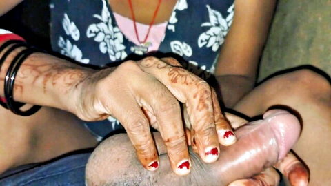 Henna-handed Indian woman with red nails grips and strokes thick erect cock