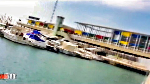 Colorful marina with docked boats and modern docks under blue sky