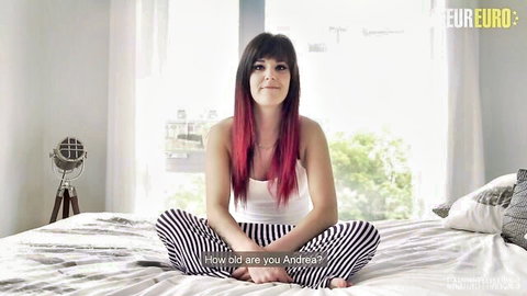 Euro redhead amateur sitting spread-legged on bed in tight white top and striped pants