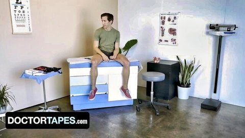 Young athletic twink in green tee and blue shorts sits on doctor's exam table in medical office