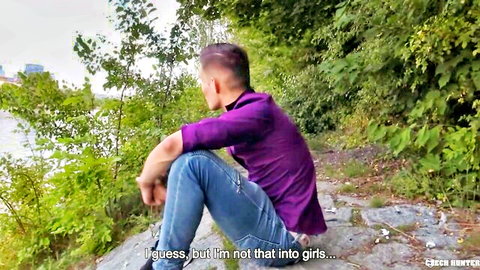Handsome gay guy in purple shirt and jeans sits by river confessing he's not into girls outdoor pickup tease