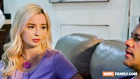Petite blonde stepdaughter in purple top faces stepdad on couch in taboo family scene