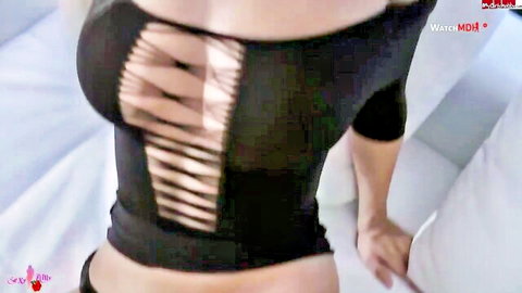Busty babe exposing huge tits through black cutout top bending over bed pillows