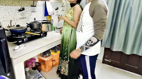 Sexy Indian wife in green saree cooks while husband gropes her hips from behind in homemade kitchen tease
