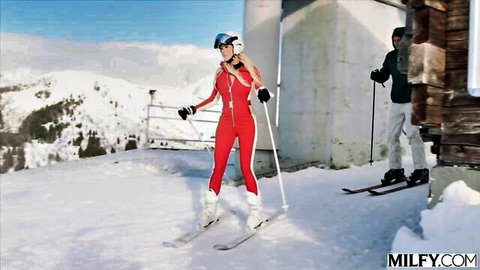 Brandi in tight red ski suit skiing with big tits on snowy slopes