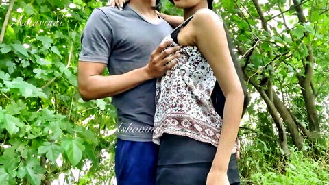 Indian couple embracing passionately in forest outdoors, naughty standing hug tease