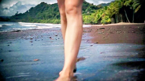 Ivy Wolfe in white bikini bottoms walking on tropical beach in Honeymoon Part 2