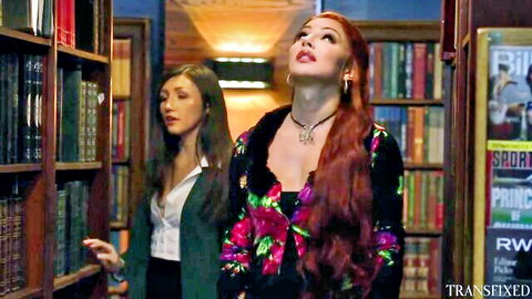 Redhead trans babe with big tits and brunette tease in library for wild fuck