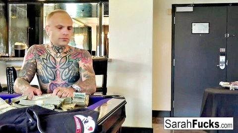 Tattooed bald man stacks thick cash stacks on purple pool table in bar