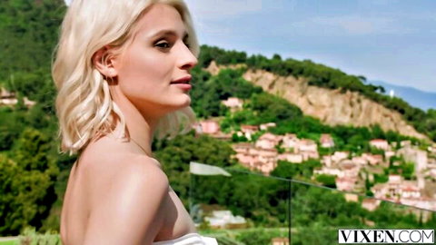 Blonde Christy White in seductive white dress on scenic balcony, Vixen