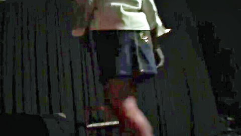 Flexible trans babe in shiny top and tight shorts lifts leg high teasing on dark stage