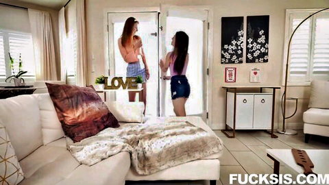 Two hot teen sisters in tiny denim shorts teasing playfully by the door in luxurious living room