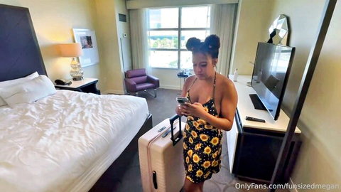 Petite black OnlyFans model Fun Sized Megan in revealing floral dress, checking phone