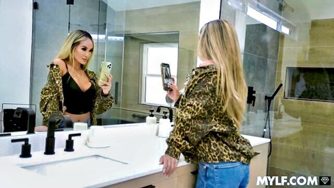 Blonde MILF Linda Lan in leopard jacket and black bra mirror selfie