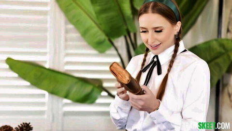 Naughty skinny brunette teen in schoolgirl shirt holds thick brown dildo smiling teasingly