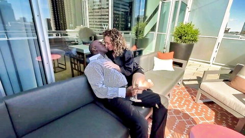Lady Thalie intimately kissing black man's neck in passionate embrace