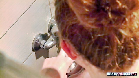Redhead babe bent over in steamy shower gripping showerhead on her pussy