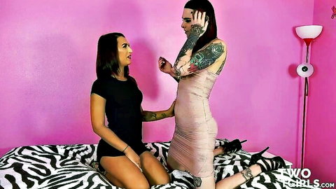 Tattooed brunette and goth girl in tight outfits kneeling teasingly on zebra bed in pink bedroom