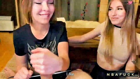 Two smiling teen girls in tight tops posing playfully on hotel bed with 'I like pain' and NSA fuck watermarks