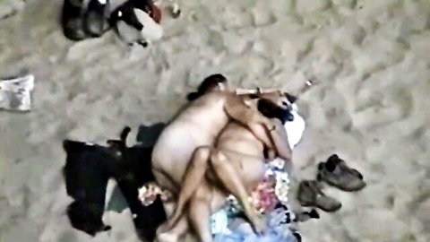 Naked couple fucking missionary on beach with clothes nearby outdoor sex