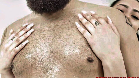 Latina babe with long white nails gropes hairy bearded man's bare chest in nude embrace