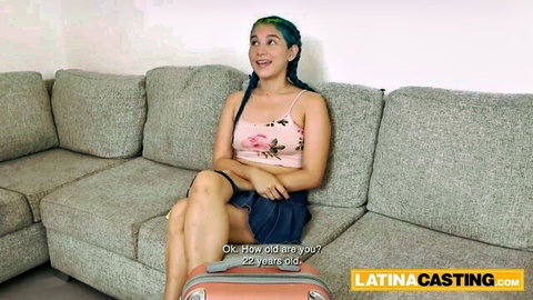 22yo sexy Latina with teal hair smiles teasingly in pink top and mini skirt at casting audition
