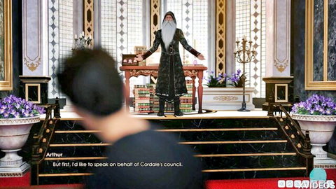 Bearded wizard in ornate robe speaks on stage before council in fantasy hall