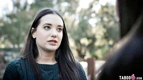 Brunette teen in green sweater stands outdoors looking seductive for taboo video