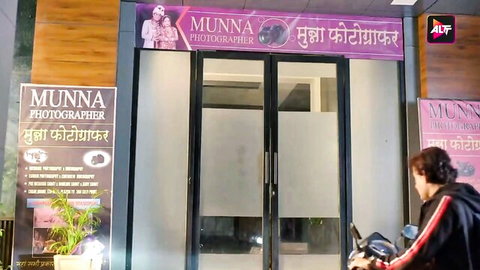 Curvy South Asian woman with big tits posing on poster at Indian Munna photographer studio storefront