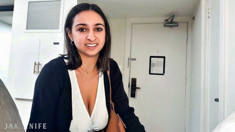 Hailey Rose smiling in low-cut white blouse showing deep cleavage and natural big tits