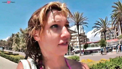 Blonde German babe in wet pink bikini on Mallorca beach