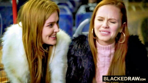 Blonde and redhead hotties in fur jackets grinning teasingly on public bus seats