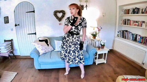 Redheaded English babe in floral dress and gloves posing in RedXXX video