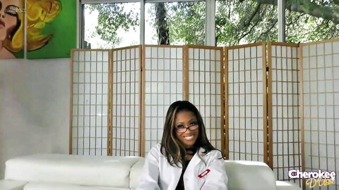 Ebony MILF Cherokee Dass smiling in sexy white lab coat on couch