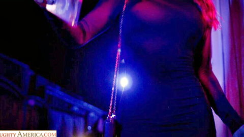 Skinny redhead stripper in sheer black dress teasing medium tits at neon strip club